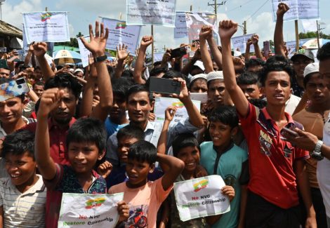 TOPSHOT - Rohingya refugees shout slogans during a "Genocide Remembrance Day" rally marking the 5th anniversary since fleeing Myanmar from a military offensive, at a refugee camp in Ukhia on August 25, 2022. Thousands of Rohingya refugees held "Genocide Remembrance Day" rallies on August 25 across the huge network of squalid camps in Bangladesh where they live in dire conditions, marking five years since fleeing from a brutal military offensive in Myanmar. (Photo by Munir uz Zaman / AFP) (Photo by MUNIR UZ ZAMAN/AFP via Getty Images)